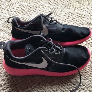 Pink and black Nike Roshes